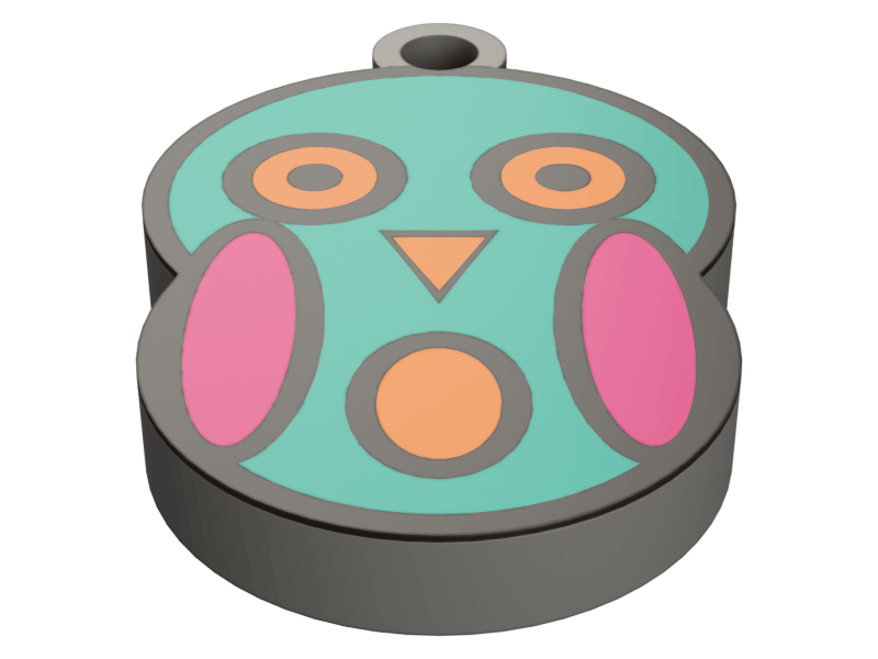 A round printed keychain fob carrying an owl face: a teal ground with two large orange-ringed eyes, a small orange beak and a round orange belly between pink side panels, all divided by gray printed outlines, with a bored keyring lug at the top